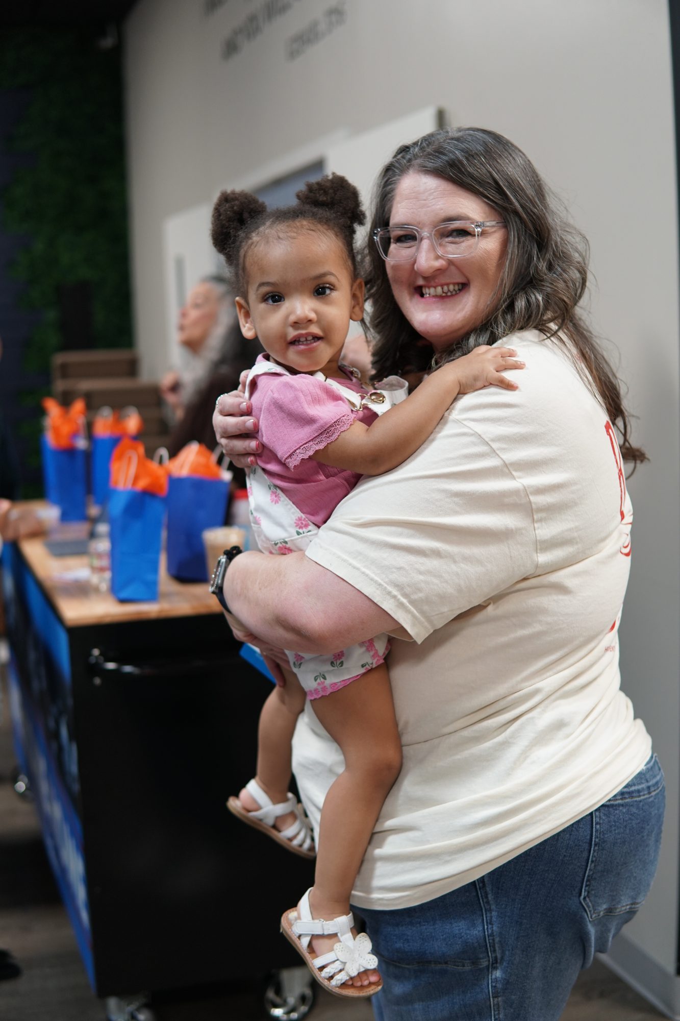 B Kids volunteer holding a toddler at Breath of Life Church