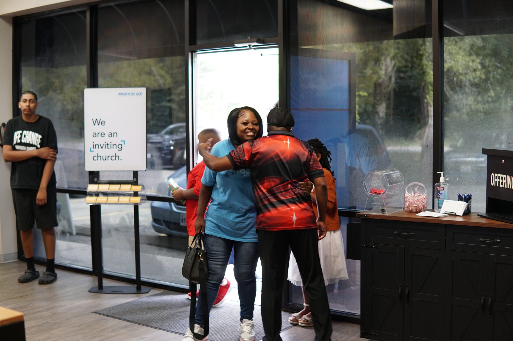 Guests being welcomed at the front door of Breath of Life Church in Conroe, TX