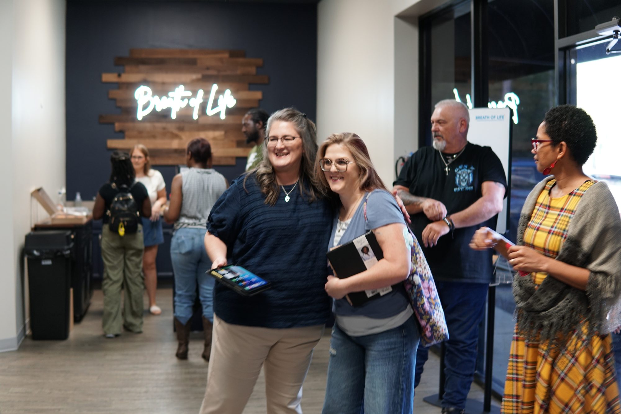 Friends greeting each other at Breath of Life Church in Conroe, TX